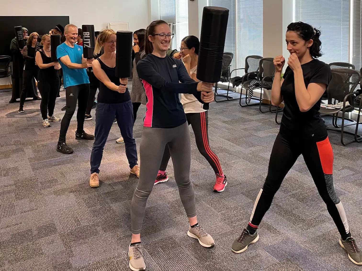 Berkshire business employees practicing martial arts during corporate wellness program